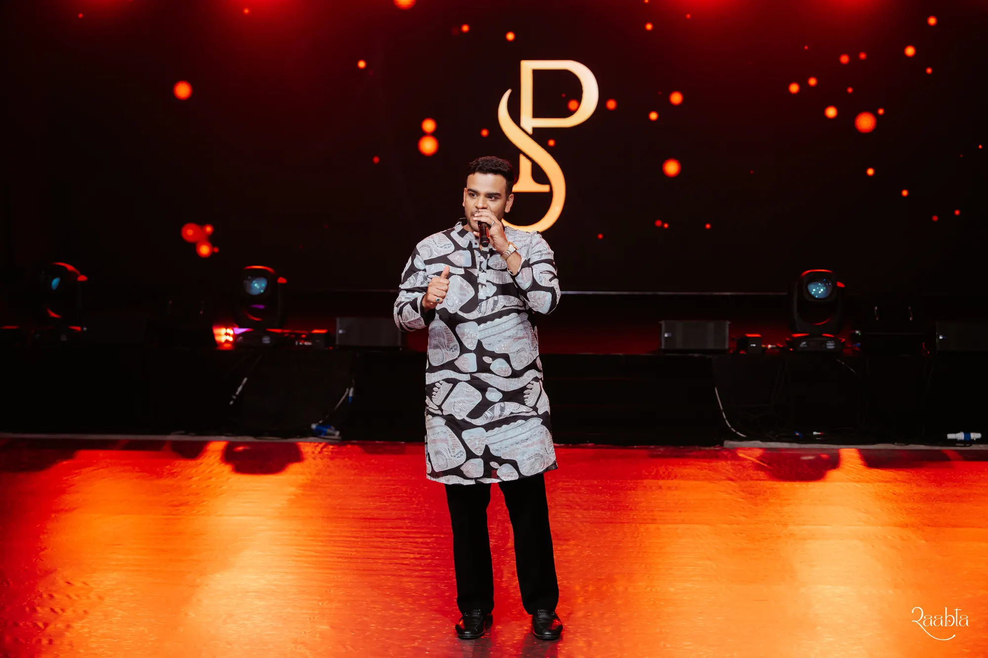Chirag Vithalani under red stage lights at Shiven and Palak's wedding in Bahrain