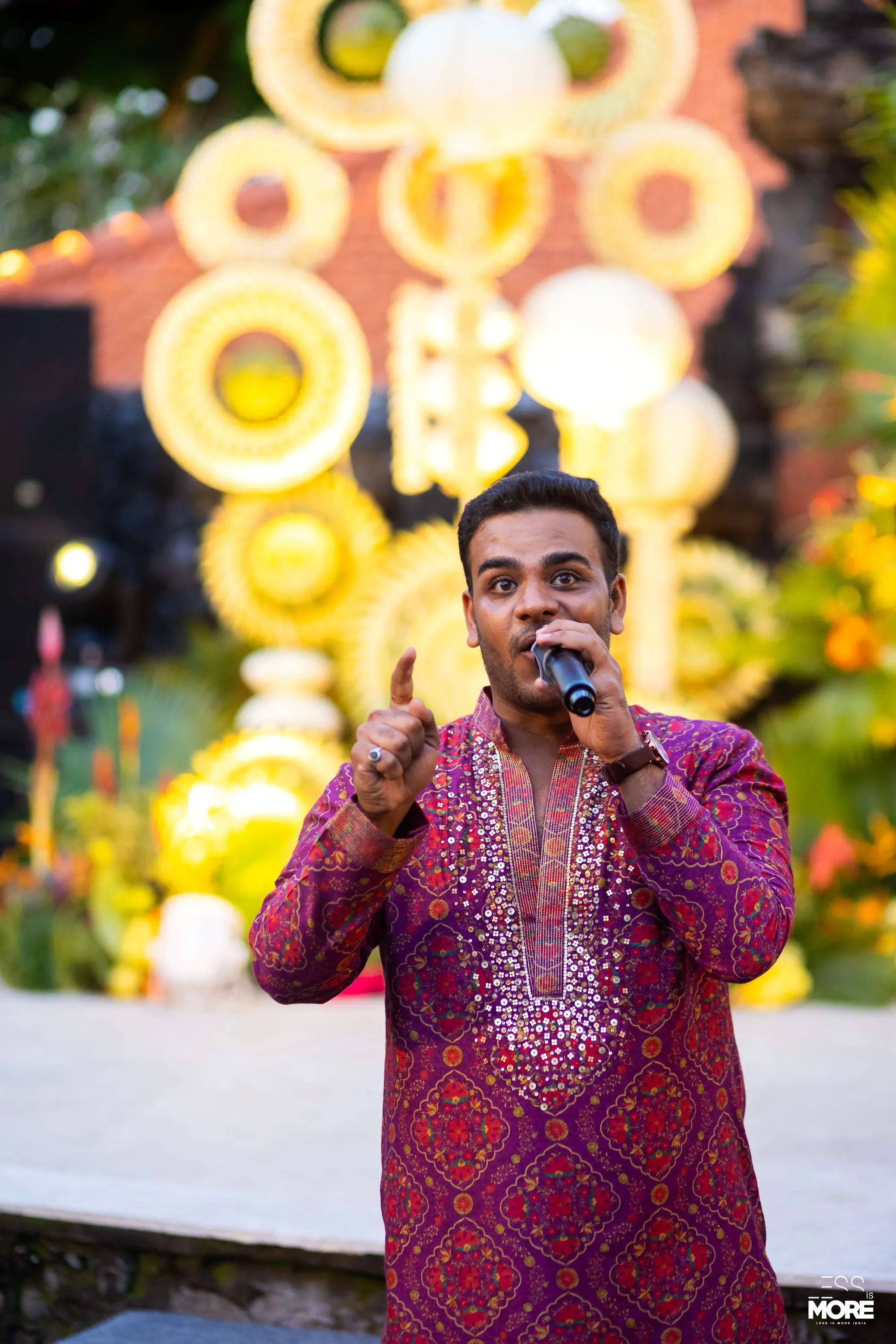 Chirag Vithalani in a pink kurta calling the crowd at Aayush and Shama's wedding, Grand Hyatt Bali