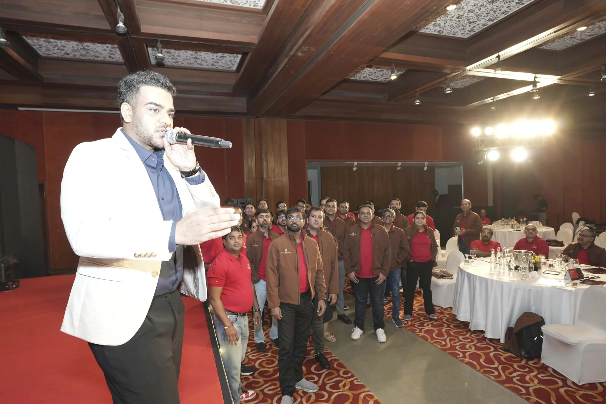Chirag Vithalani with a microphone among delegates at Barry Callebaut's Sankalp conference