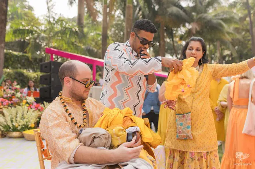 Chirag Vithalani running a game with the couple at Kyja and Jai's wedding, Taj Lands End