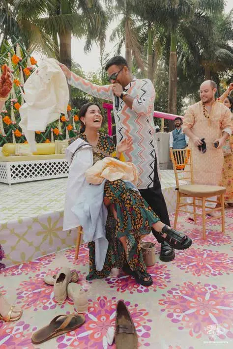The bride laughing on a swing at Kyja and Jai's wedding, Mumbai